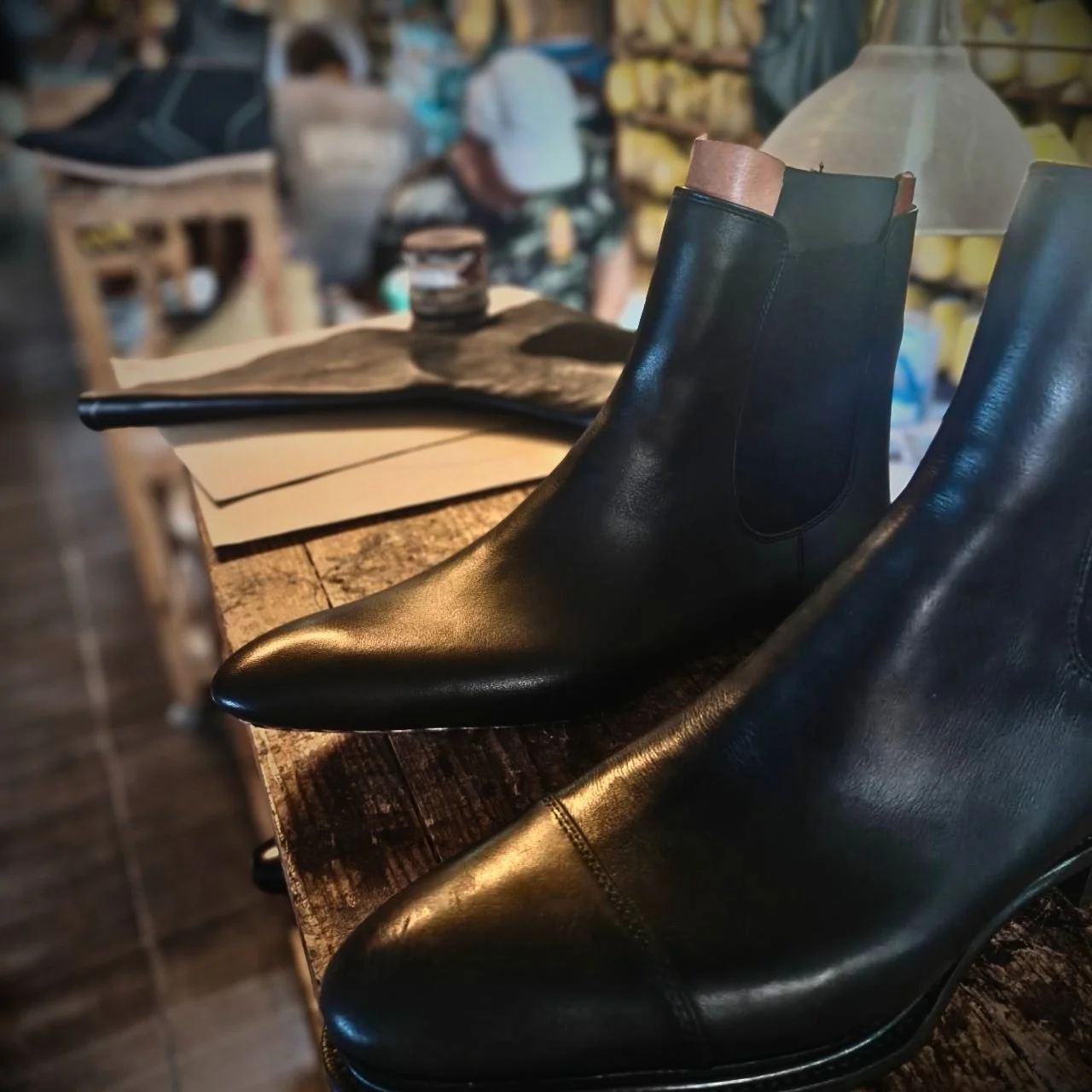A cap tow version of the Naang Boots Zissou Chelsea Boot next to our two panel entry