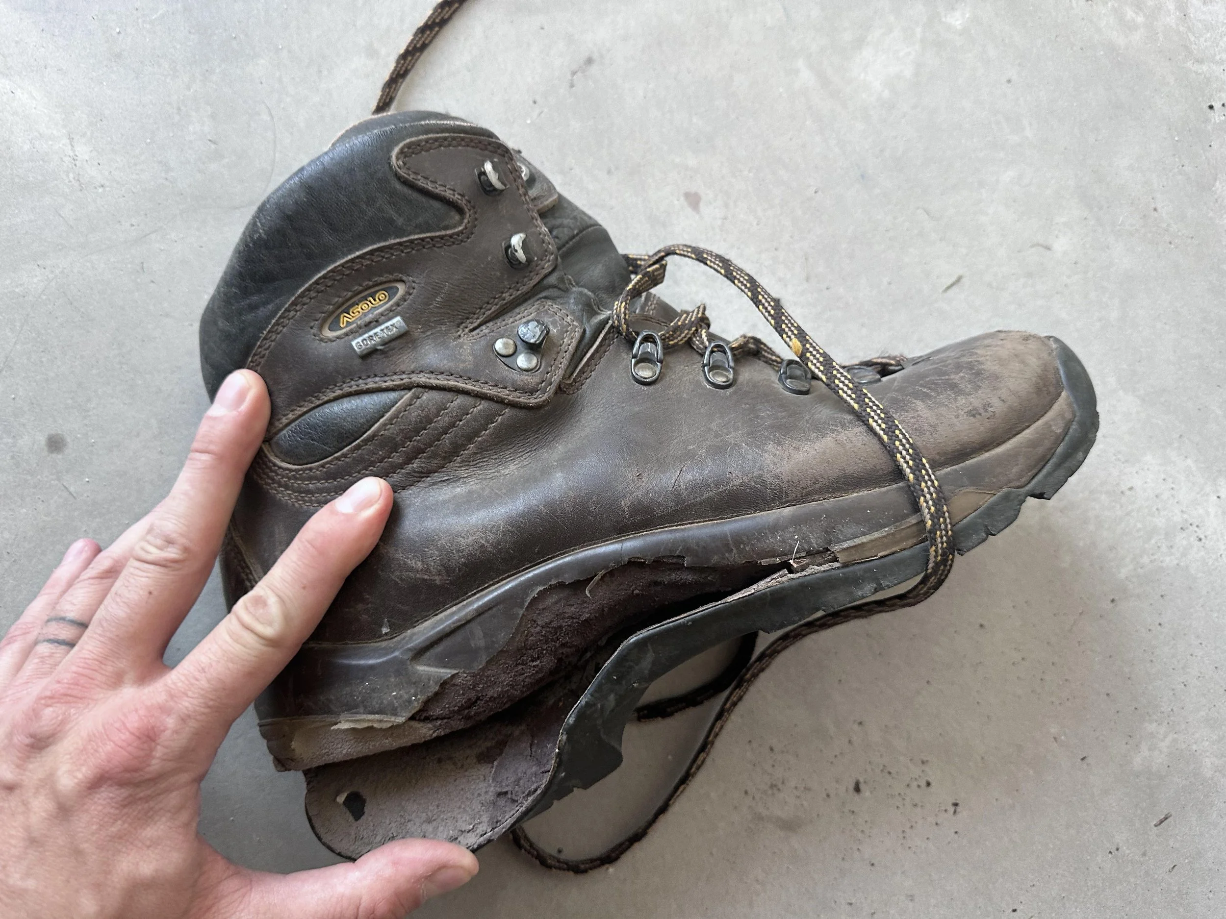 A cemented construction boot falling apart as the glue fails