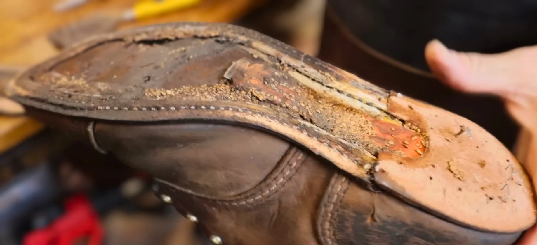 A boot being resoled filled with dry and rotted cork