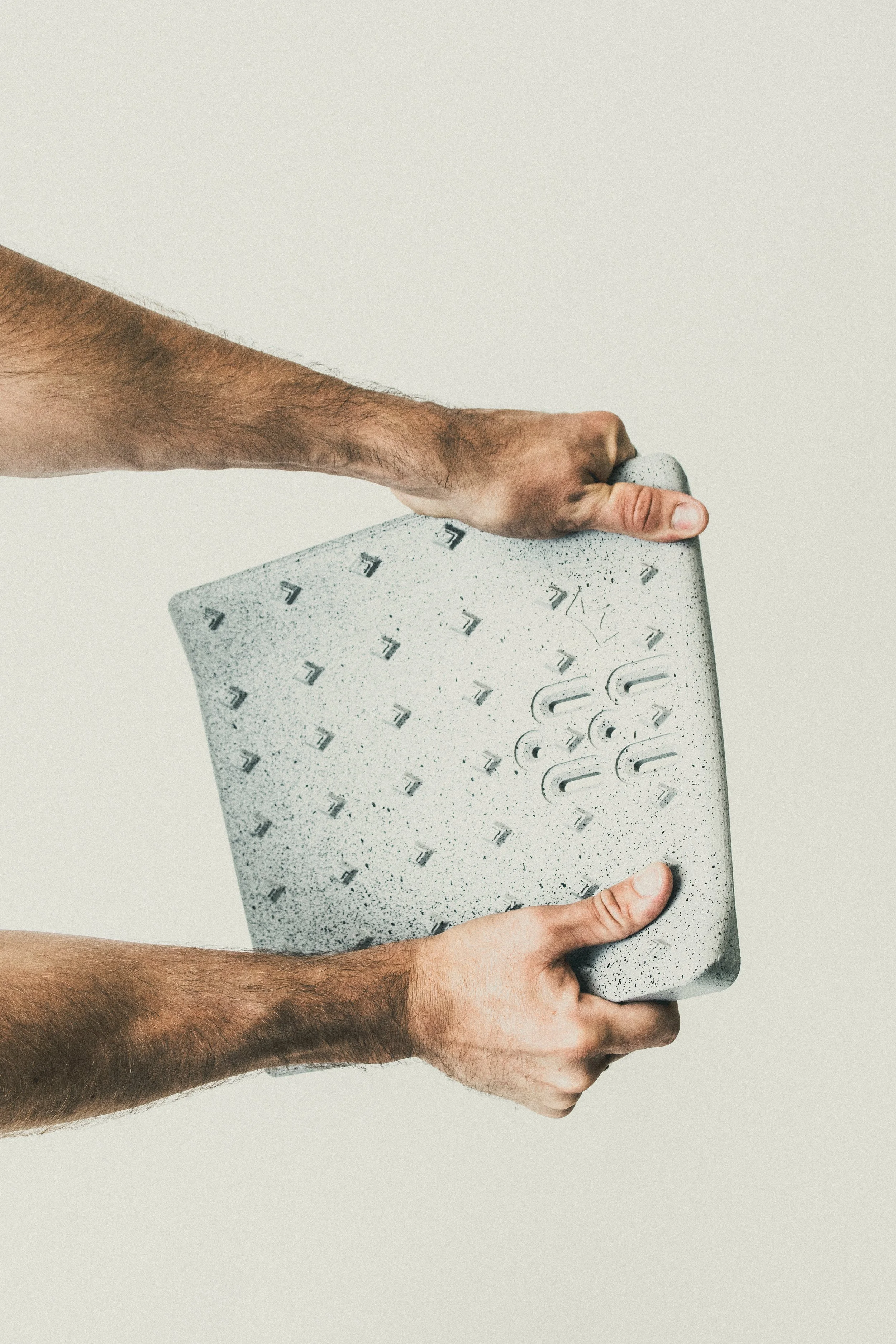 Hands flexing a Concrete Solid Pad to show the Queen Diamond Grip traction pattern