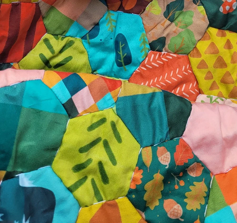 Close up of hexagon quilt in bright colors