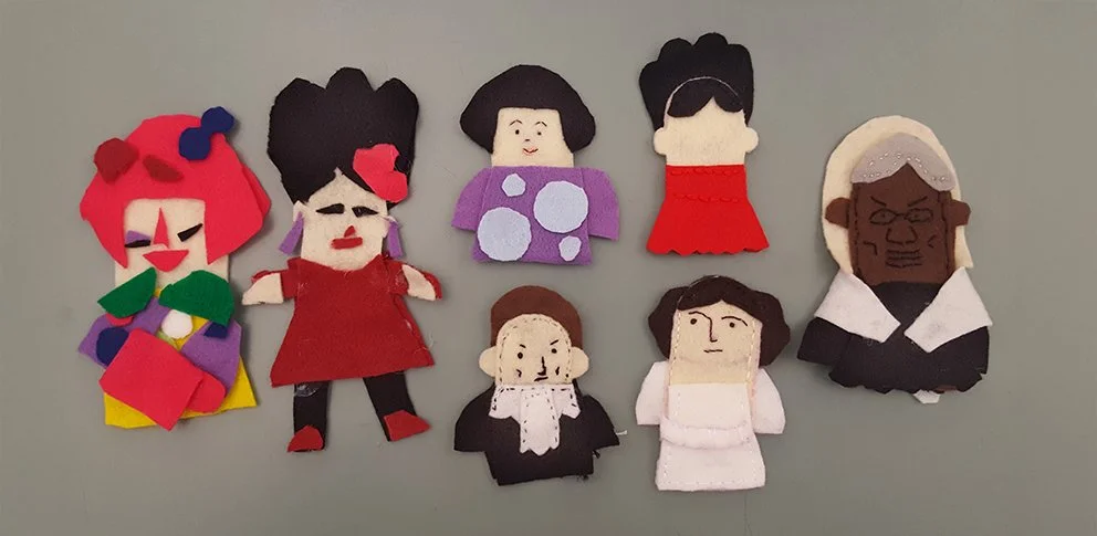 DIY felt finger puppets created by workshop participants in various sizes with bright colors. Yayoi Kusama, Frida Kahlo, Ruth Bader Ginsburg, Princess Leia, Sojurner Truth