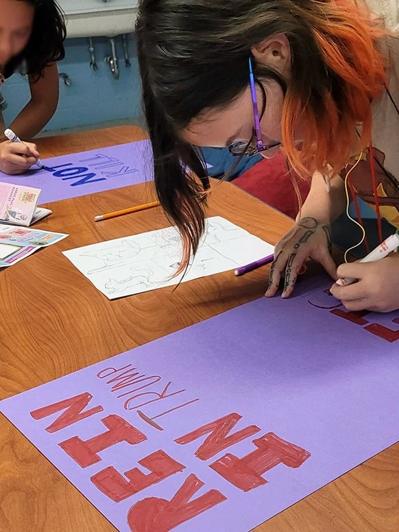 Young person drawing a poster