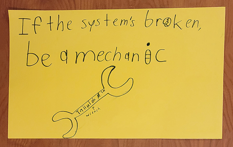 Protest poster by young workshop participants: "If the system is broken, be a mechanic"
