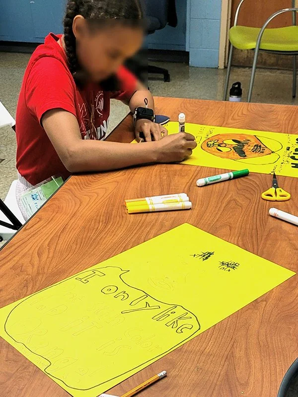 Young student drawing a poster