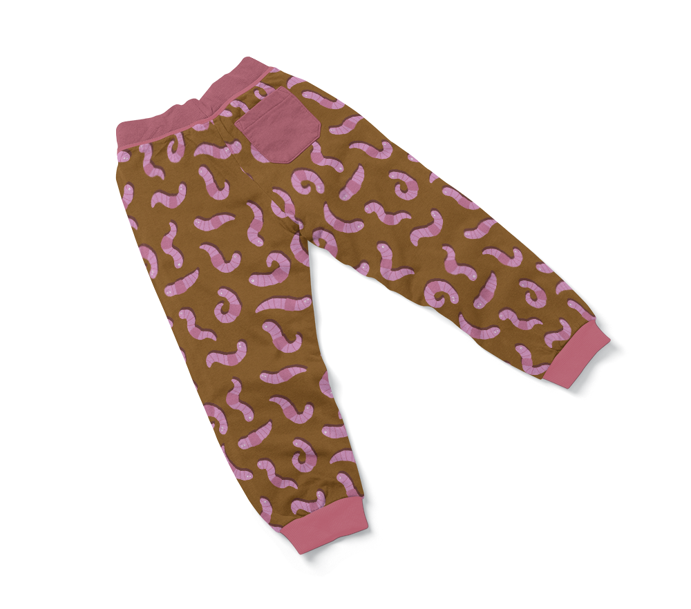 Baby jogger pants with illustrated pattern of pink worms on brown background