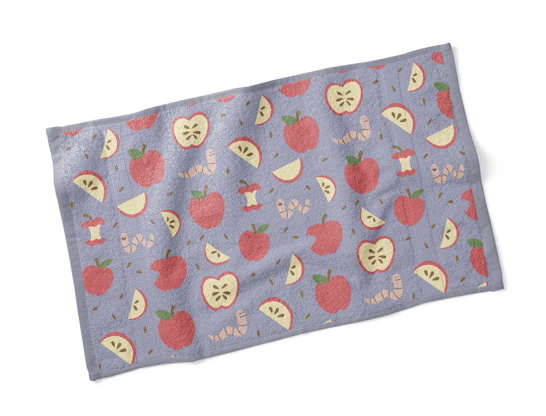 Mock up of a towel with apple and worm illustrated print