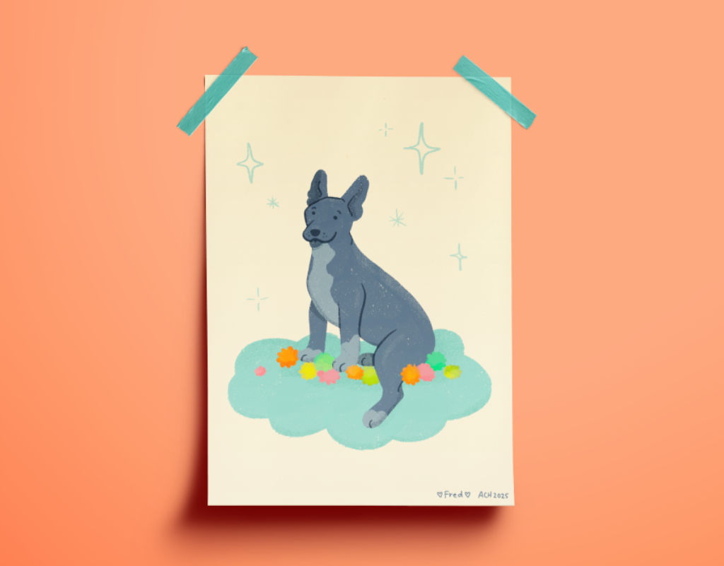 Mock-up of a print of a dog hung on a coral wall with two pieces of aqua tape. The dog is black with large ears and sitting on a cloud on a pile of bright colored yarn pompoms