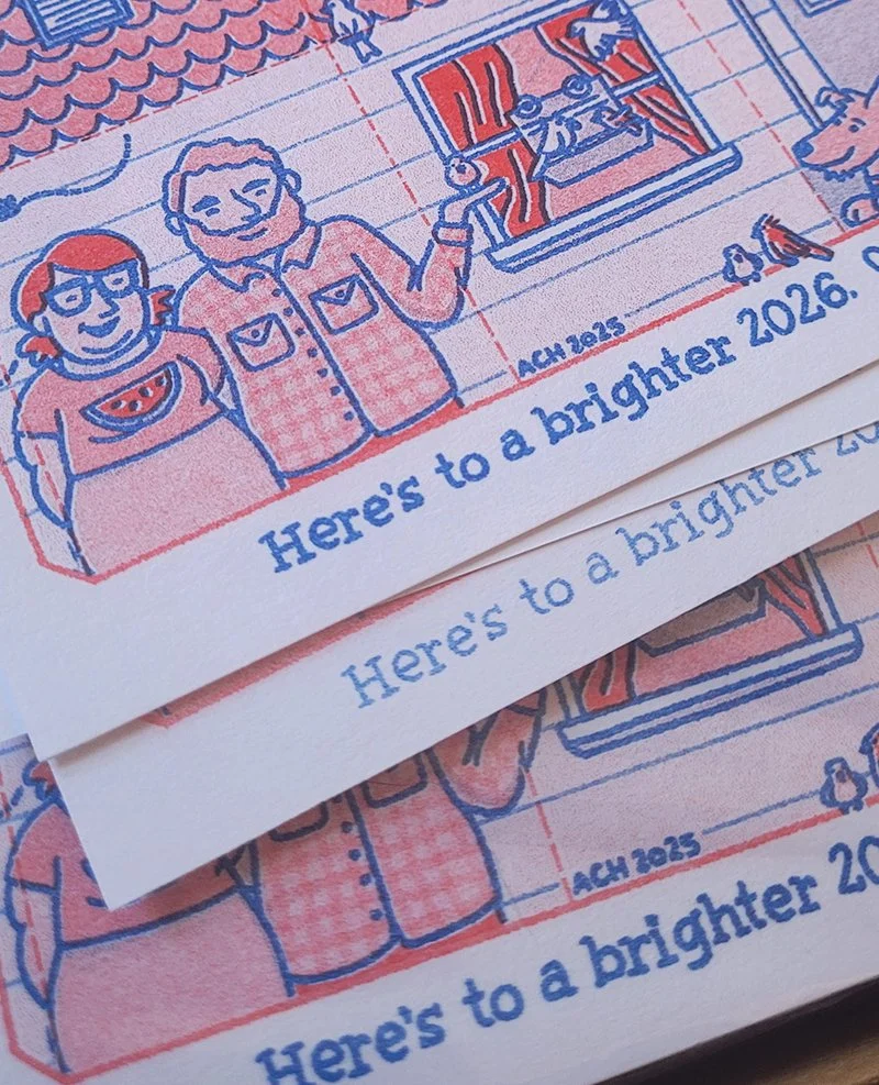 Close up of the house Riso-printed folded paper house in red and blue with Abbey and Ben standing next to a window with bird feeder and multiple birds