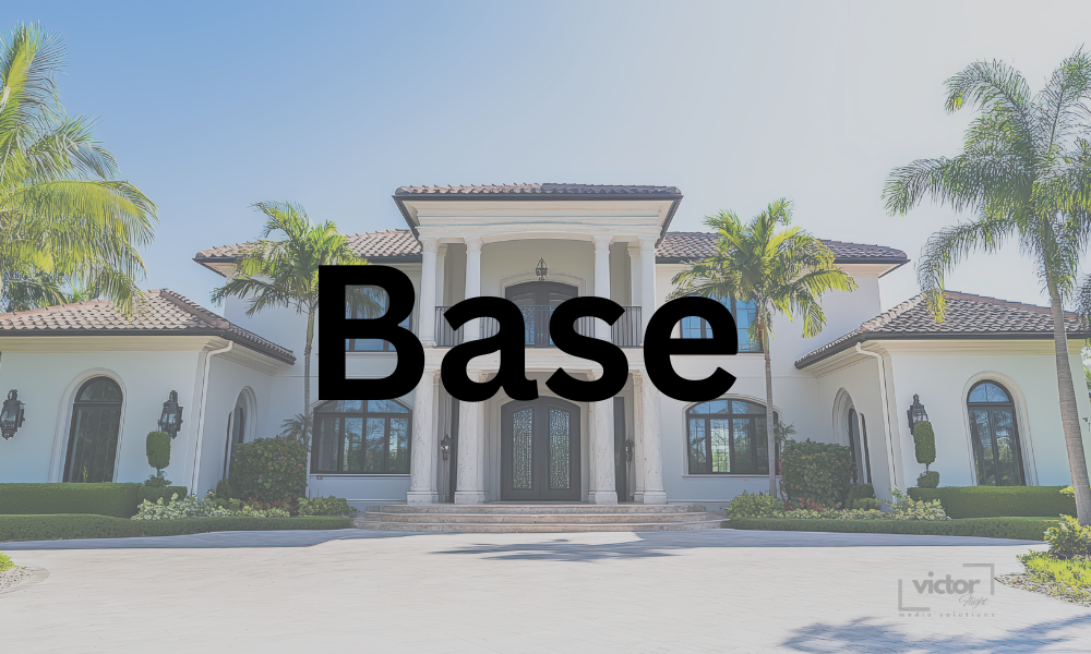 Large white mansion with columns and palm trees in front.