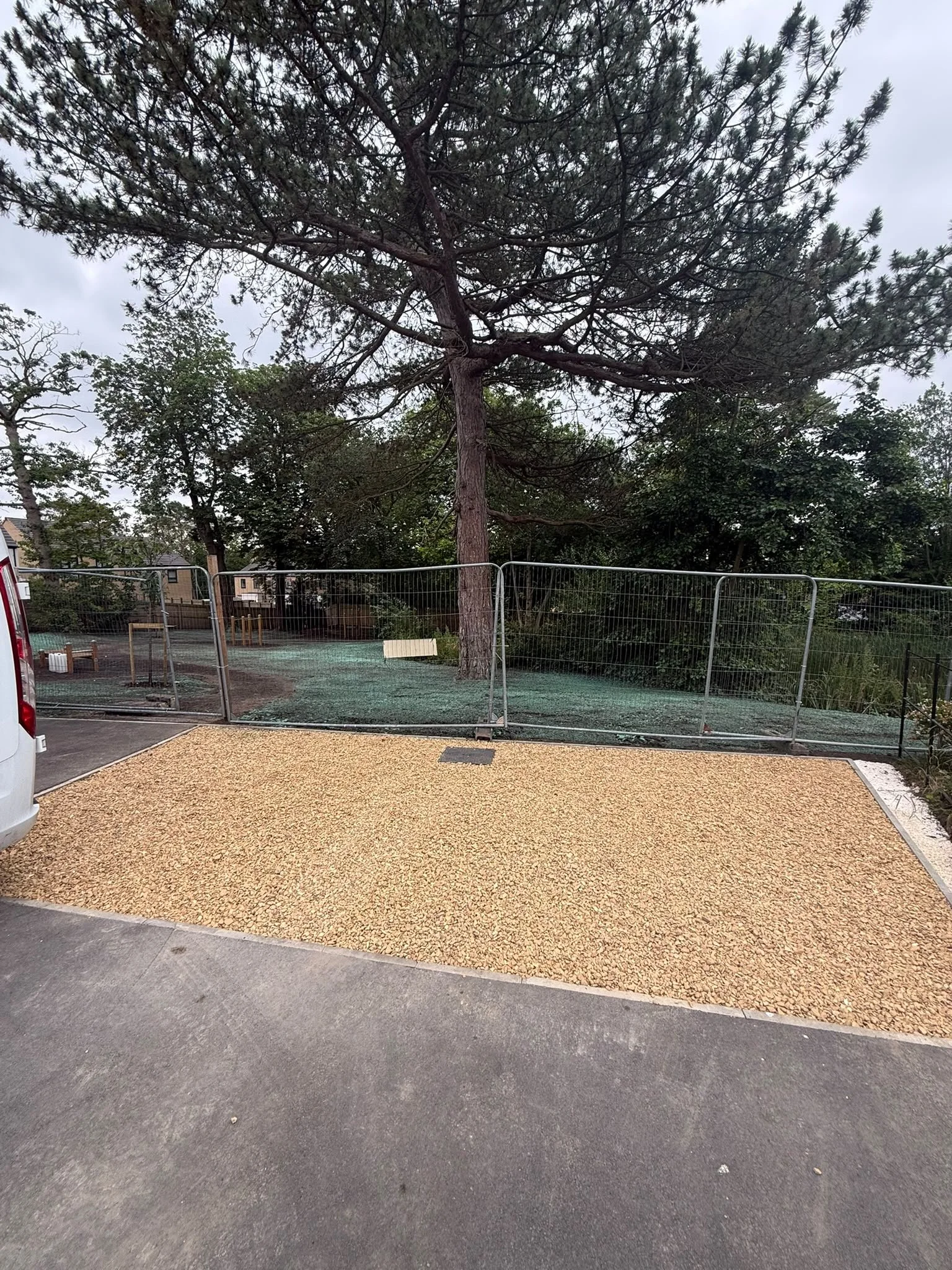 New gravel surface beside a temporarily fenced habitat area