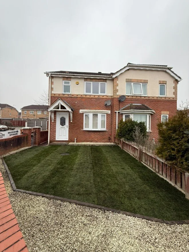 New natural turf lawn at the front of a semi-detached house