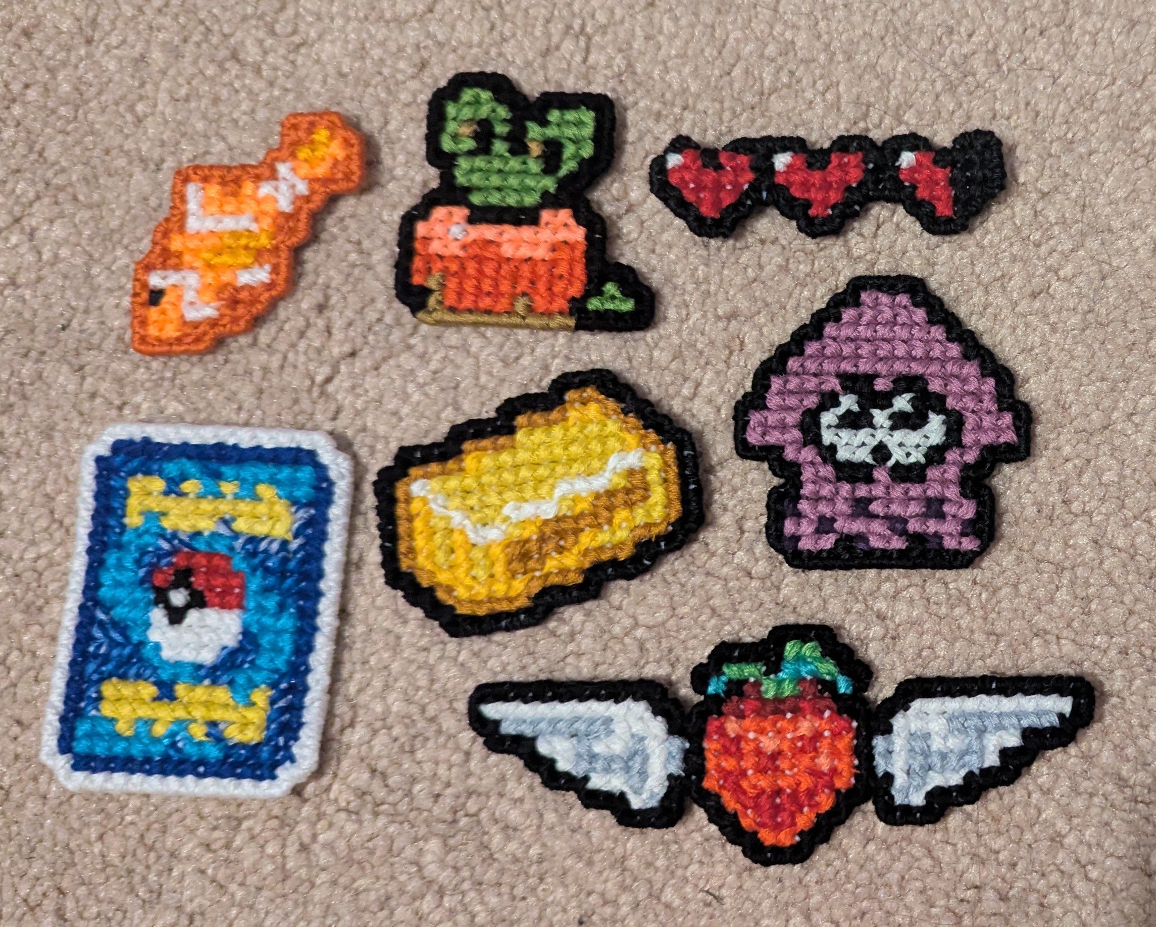 Fandom Cross Stitch Patches, 07/2025 A tropical fish, Applin, hearts, Pokemon card, gold ingot, Inkling, and flying strawberry. Check the shop to see which ones are still available! Click the picture for more.