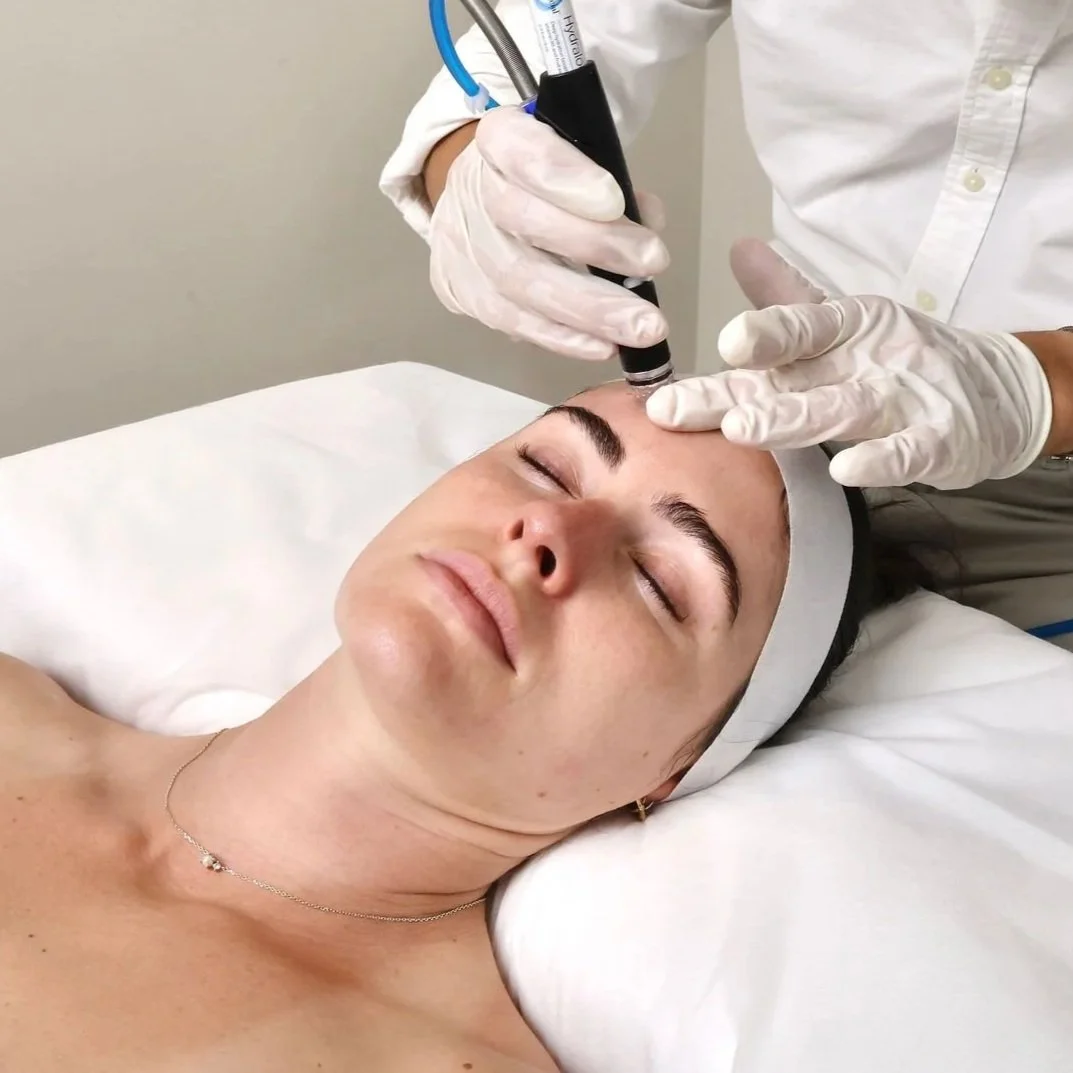 A woman lying down with eyes closed during a facial treatment, receiving a HydraFacial at Face Factor in Bondi Junction in Sydney's Eastern Suburbs. Face Factor is a clinic specialising in personalised clinical skin treatments.