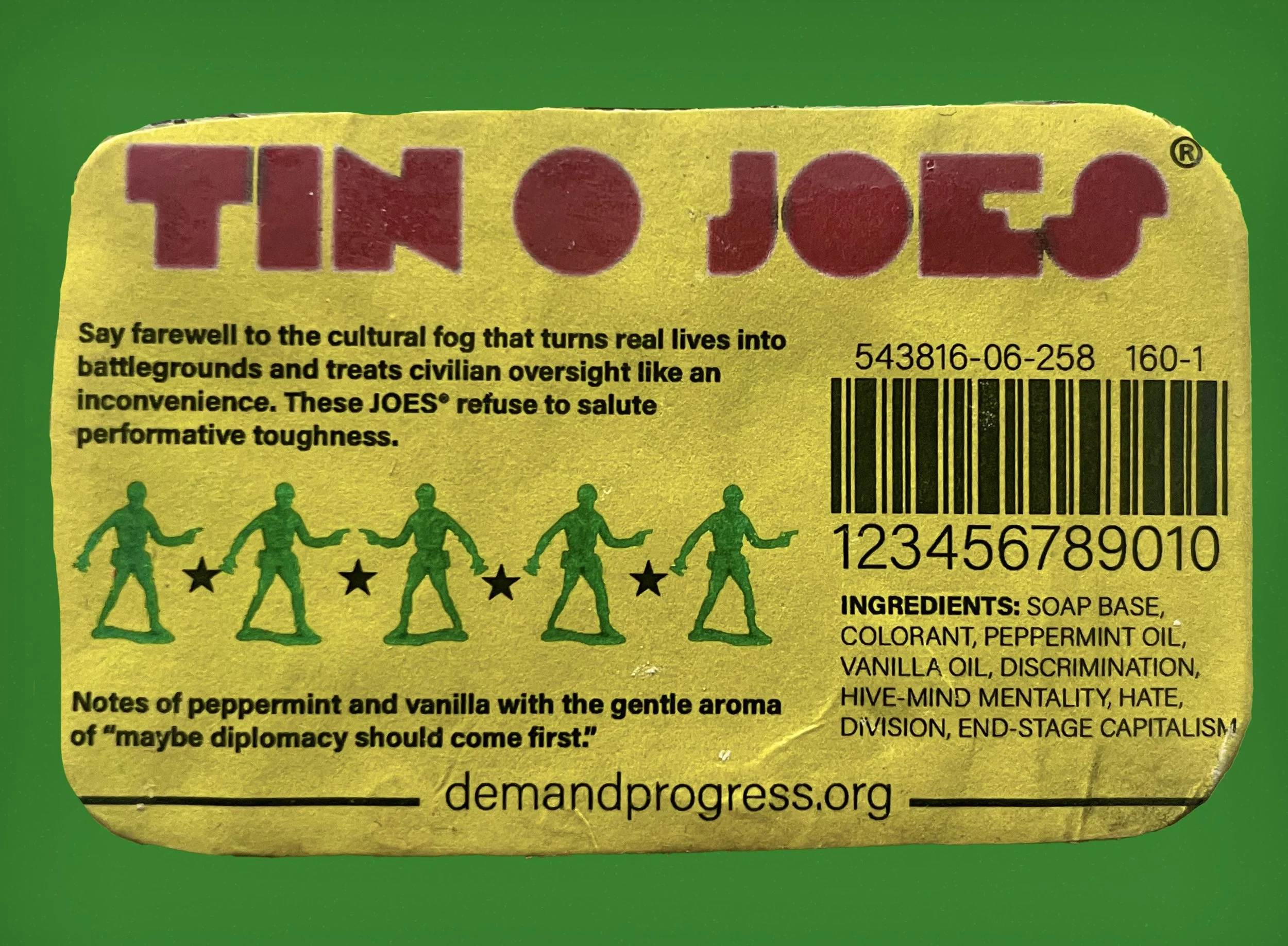 Colorful packaging resembling a soap wrapper with the title 'TIN O JOES' in large red letters. The label has humorous text that criticizes militarism and societal issues, with a row of green stick figures dancing between black stars and a barcode. It lists ingredients including soap base and oils, along with mention of political themes.