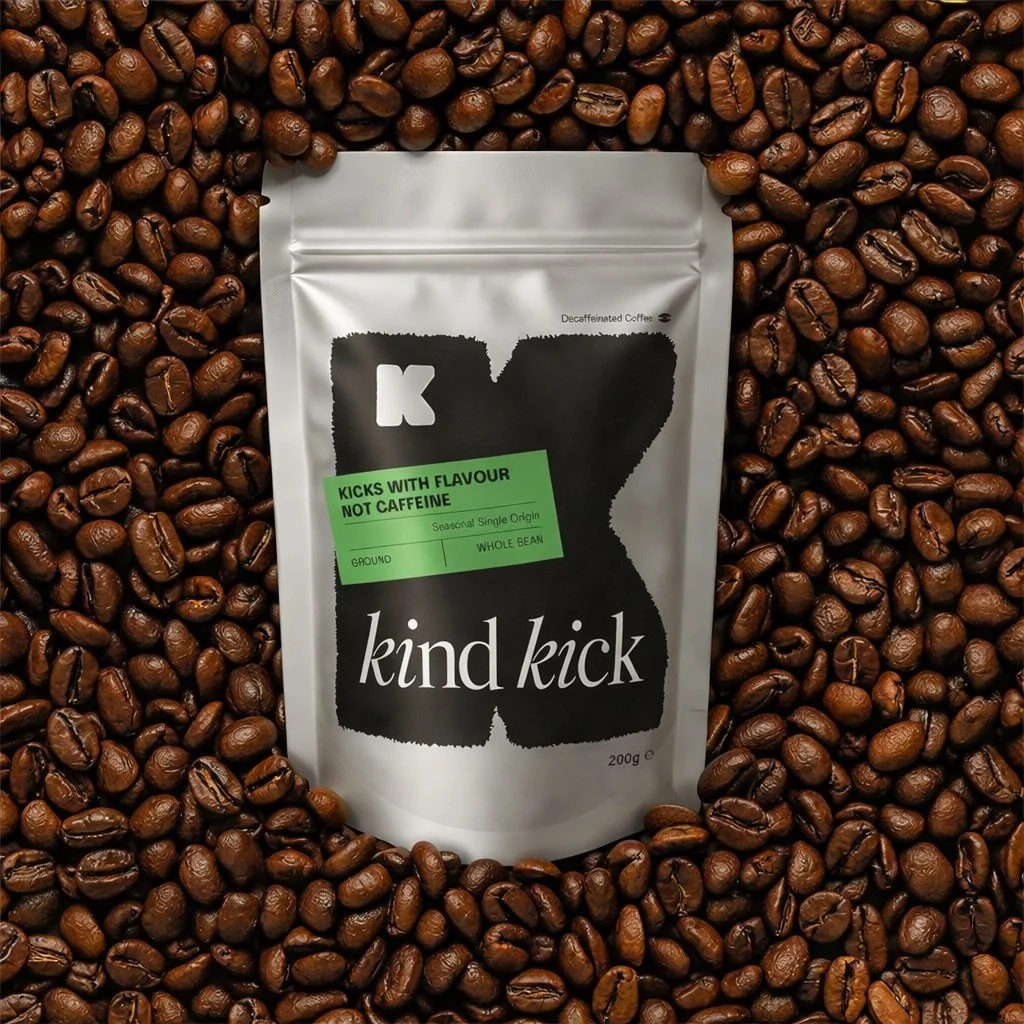 Kind Kick decaf coffee bag on roasted coffee beans