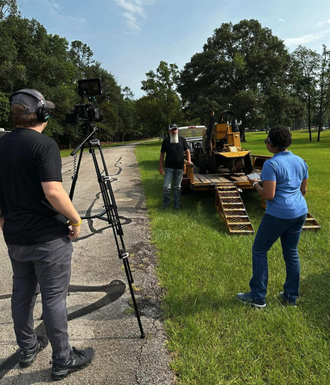Freelance videographer at left while Melyssa, at right, conducts interview with customer