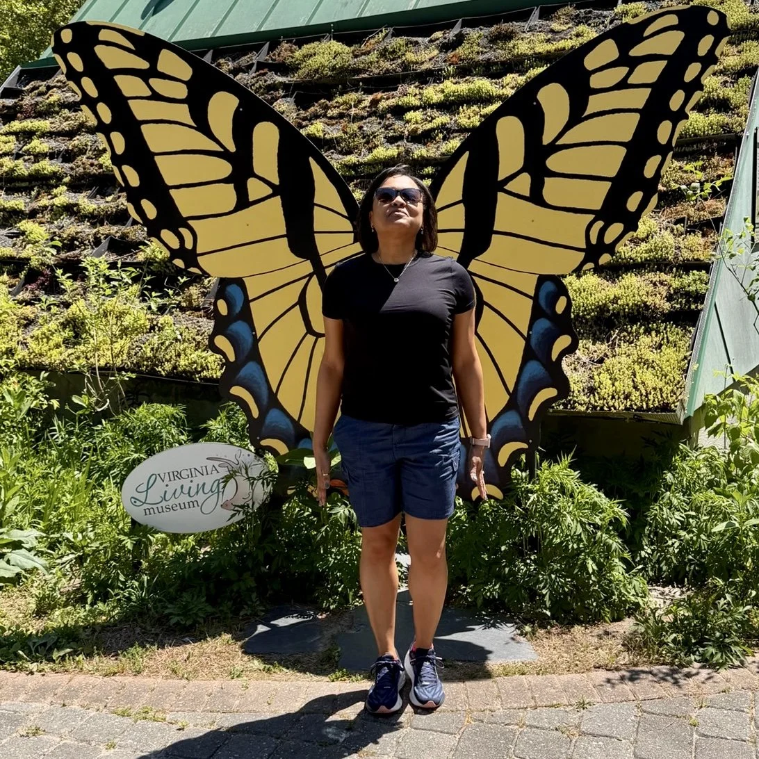 Melyssa posed with monarch butterfly wings behind her