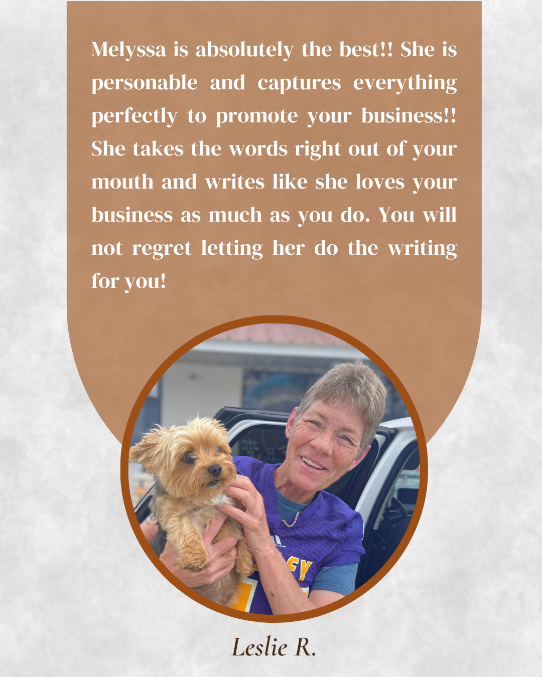 lady holding Yorkie dog in parking lot