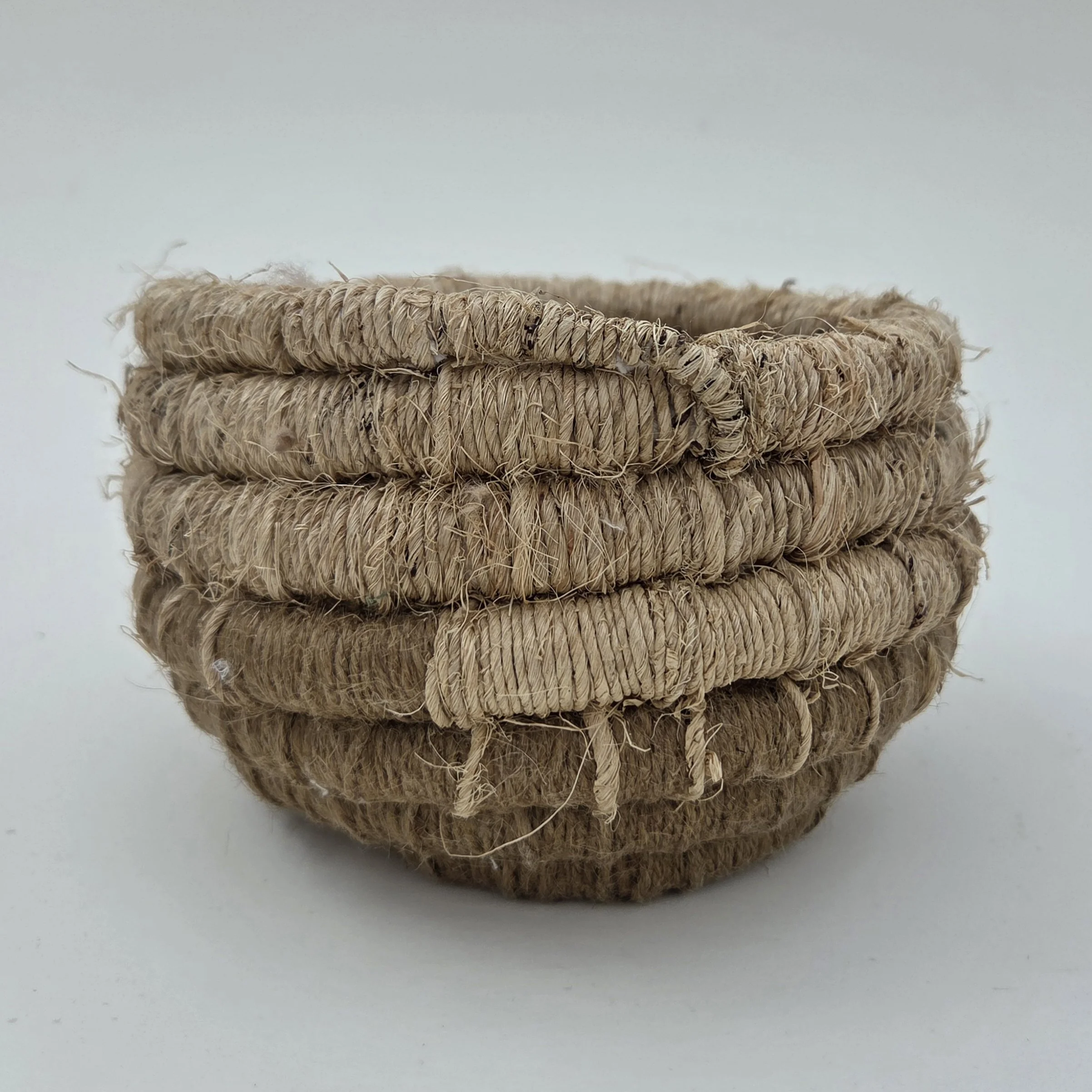 Tan handcrafted 8"x6" natural fiber coil basket