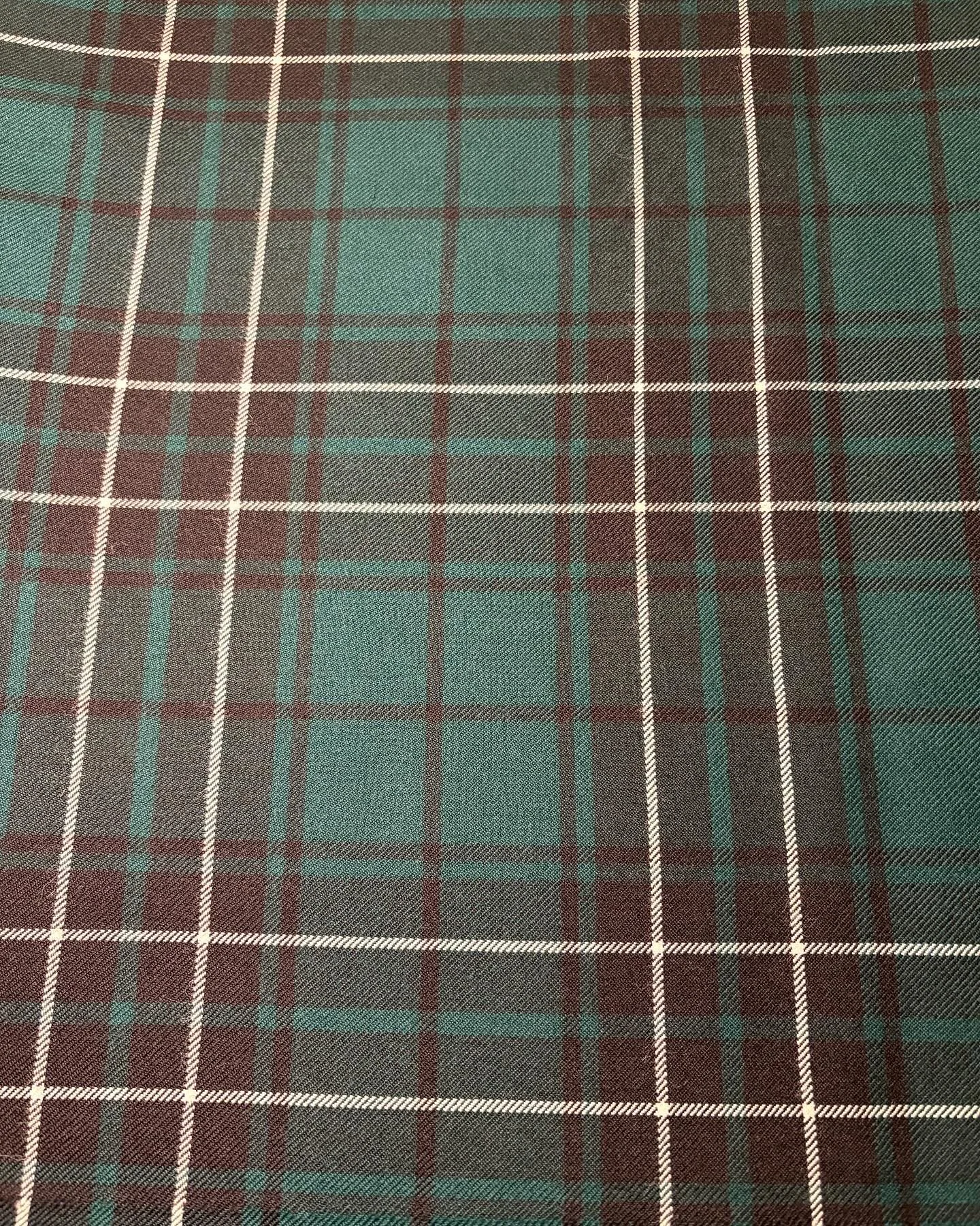 Maclean hunting modern tartan from @lochcarron_of_scotland. Pleating options for the various elements include to the sett, to the white stripe, black stripe on green and green stripe on black.
