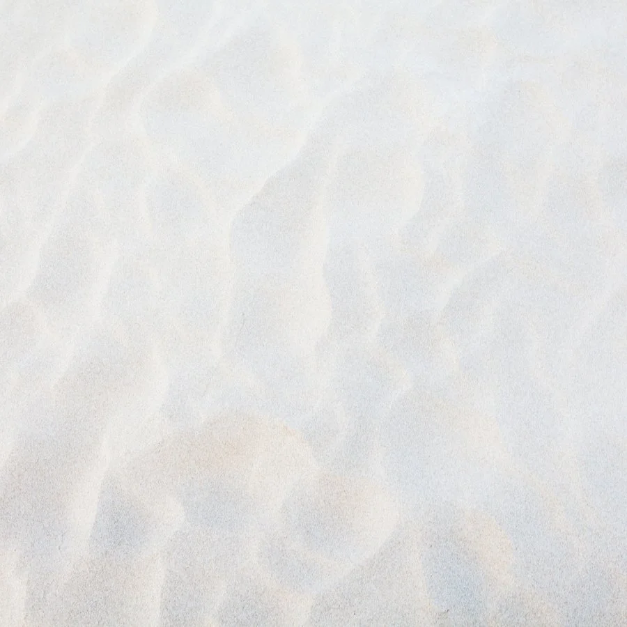 Faint, abstract, textured background with light, pastel shades of gray and beige.