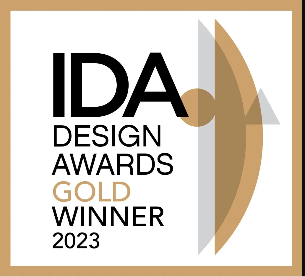 IDAA Design Awards 2023 Gold Winner badge with abstract geometric shapes and a gold, gray, and white color scheme.