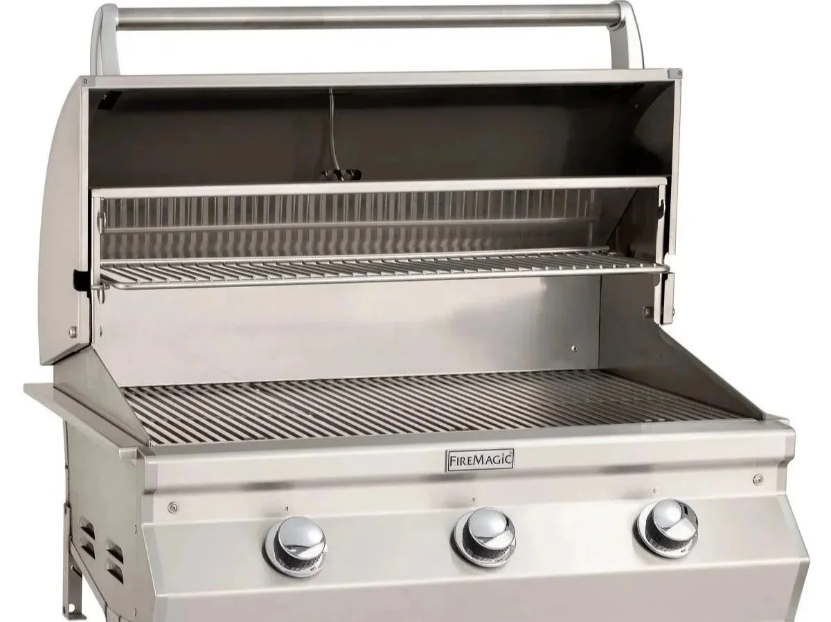 Fire Magic Choice C540i 30-inch built-in gas grill with hood open, stainless steel design, three control knobs, and spacious cooking surface