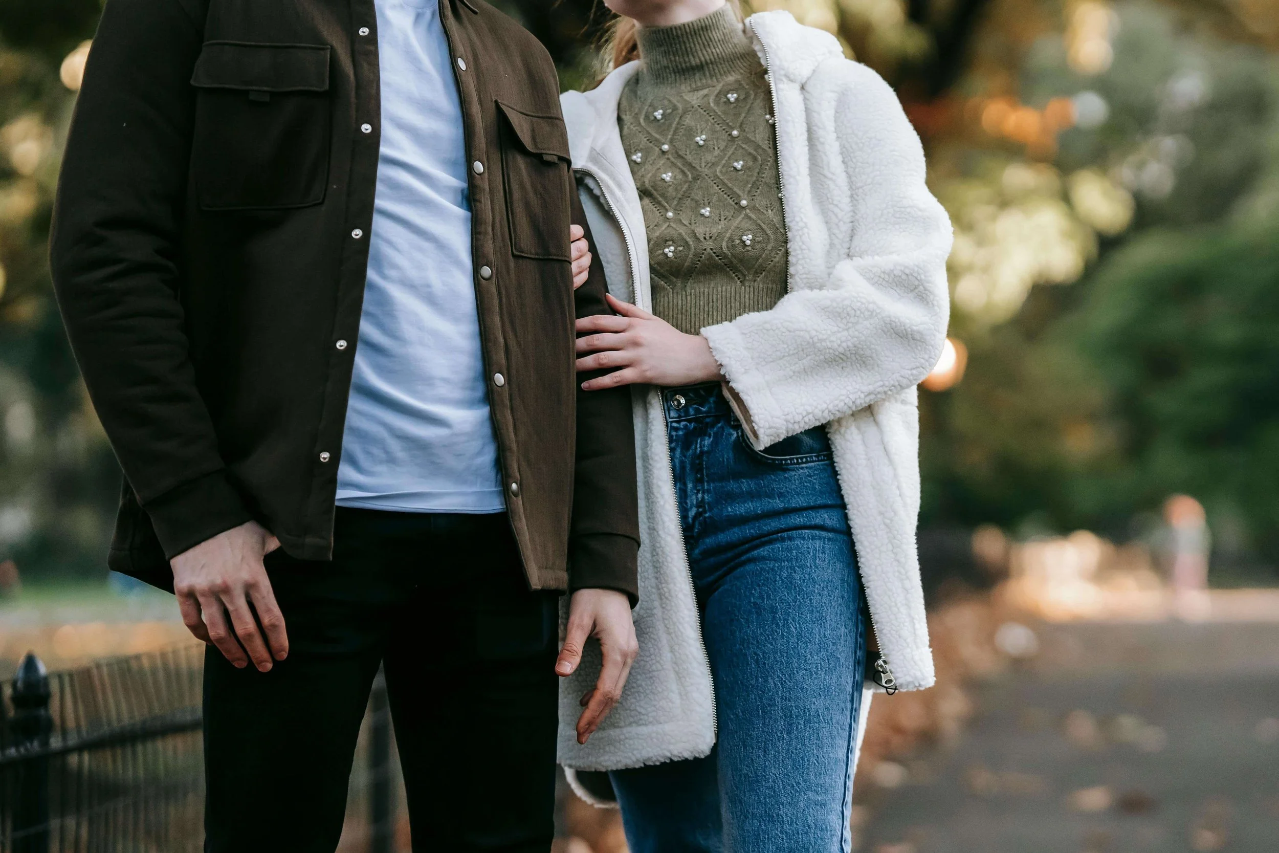 A couple wearing coats walking arm in arm outside. ERP therapy in Boston, MA can help with relationship OCD & doubt. Reach out today to learn more.