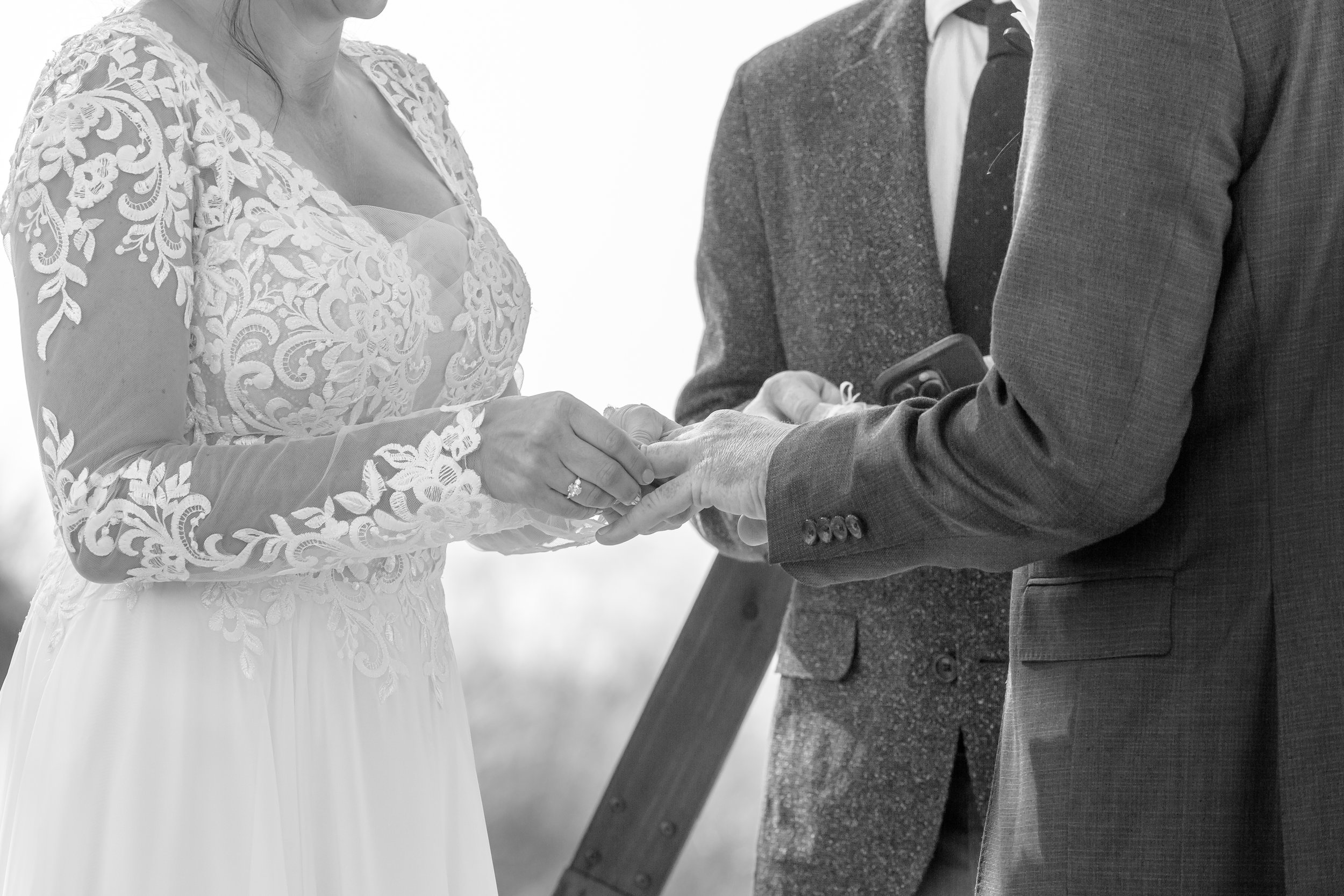 A bride and groom exchanging rings during a wedding ceremony.