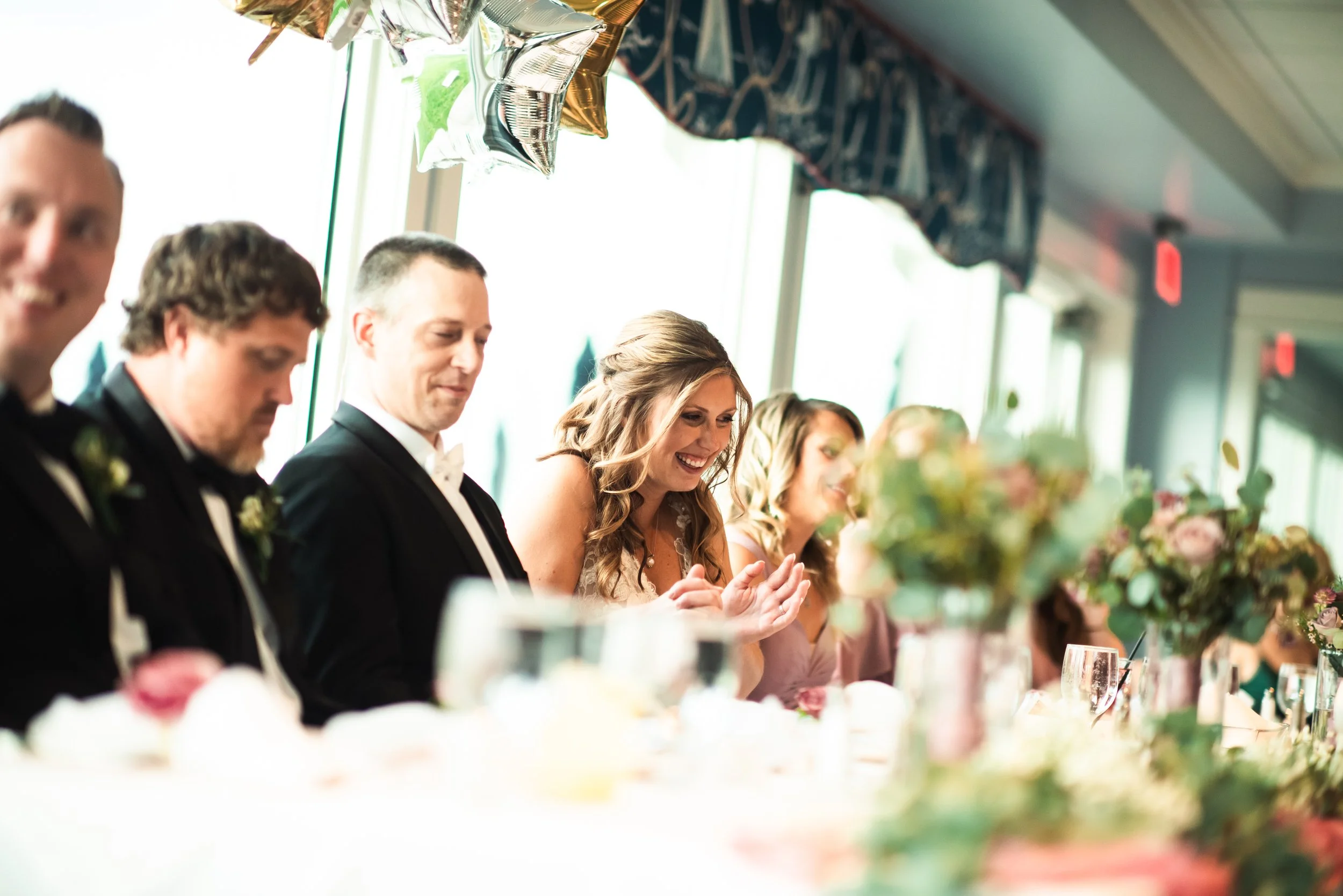 Laurie’s customers, Mariana and Carmen holding hands on a green lawn on their wedding day.
