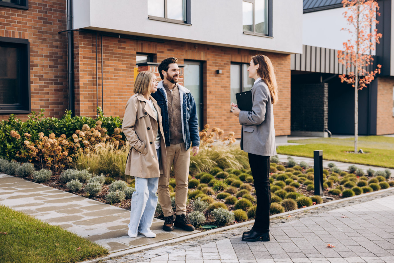couple interacting with realtor outside