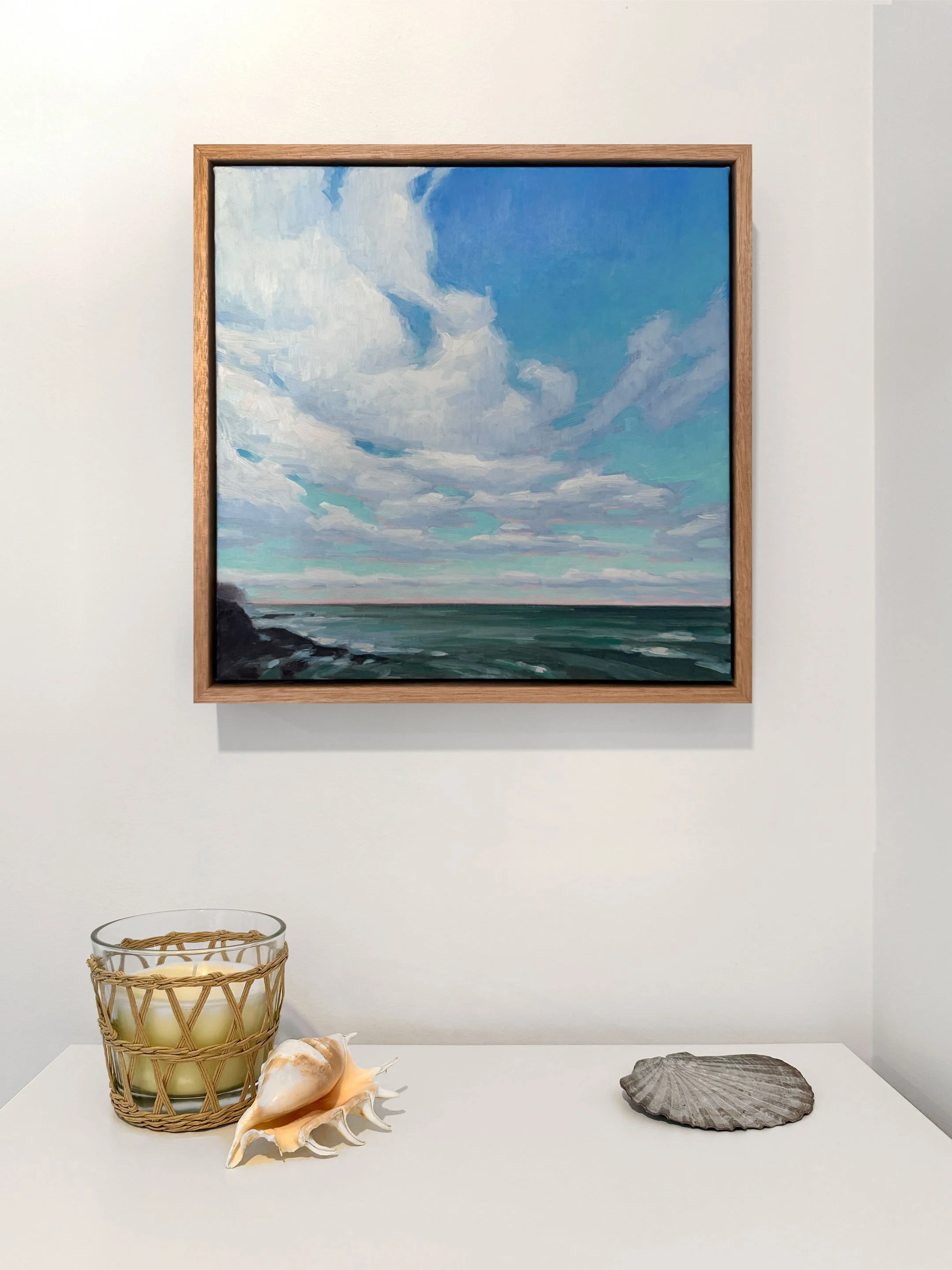 Gallery wall with four paintings in natural light