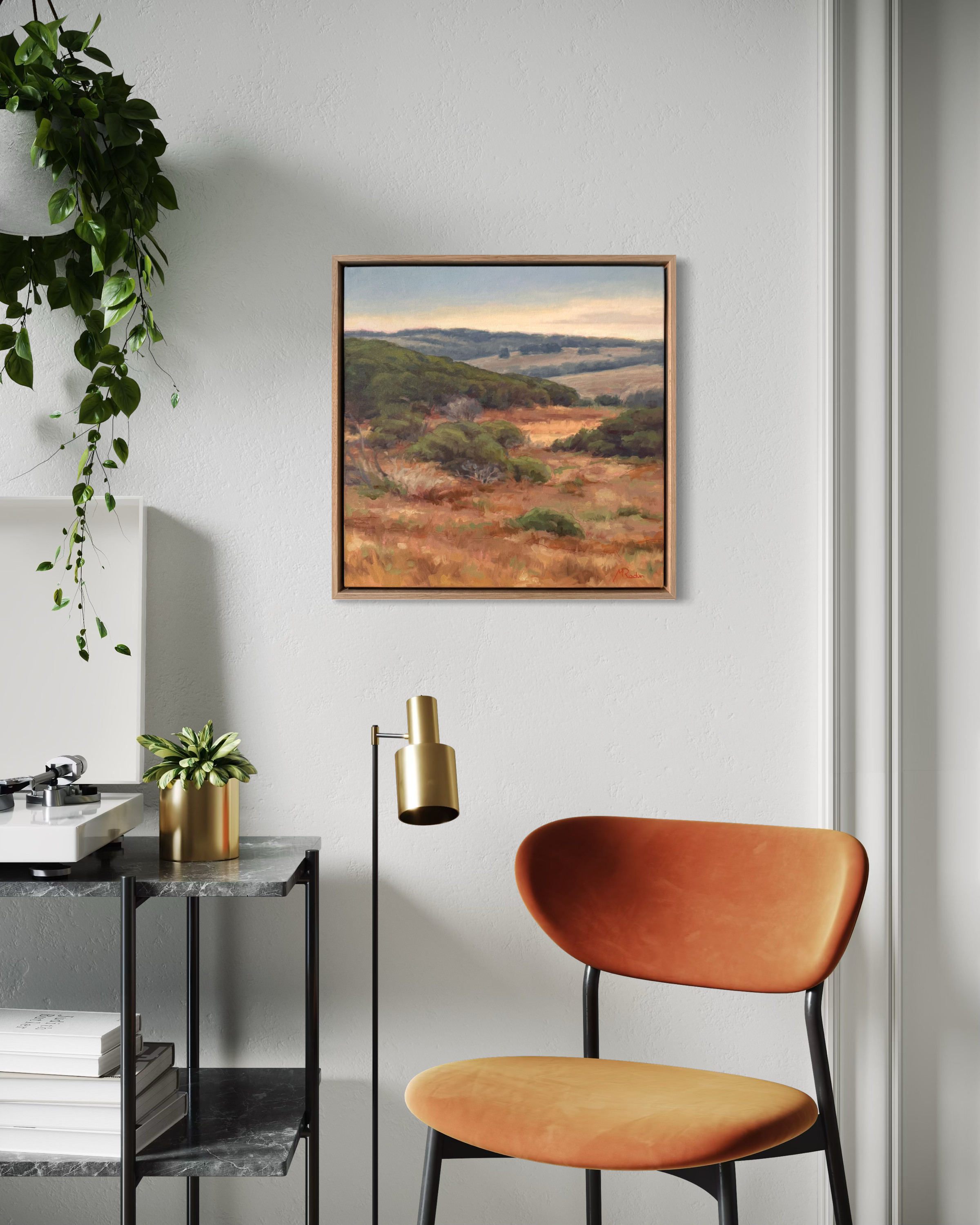 Gallery wall with four paintings in natural light