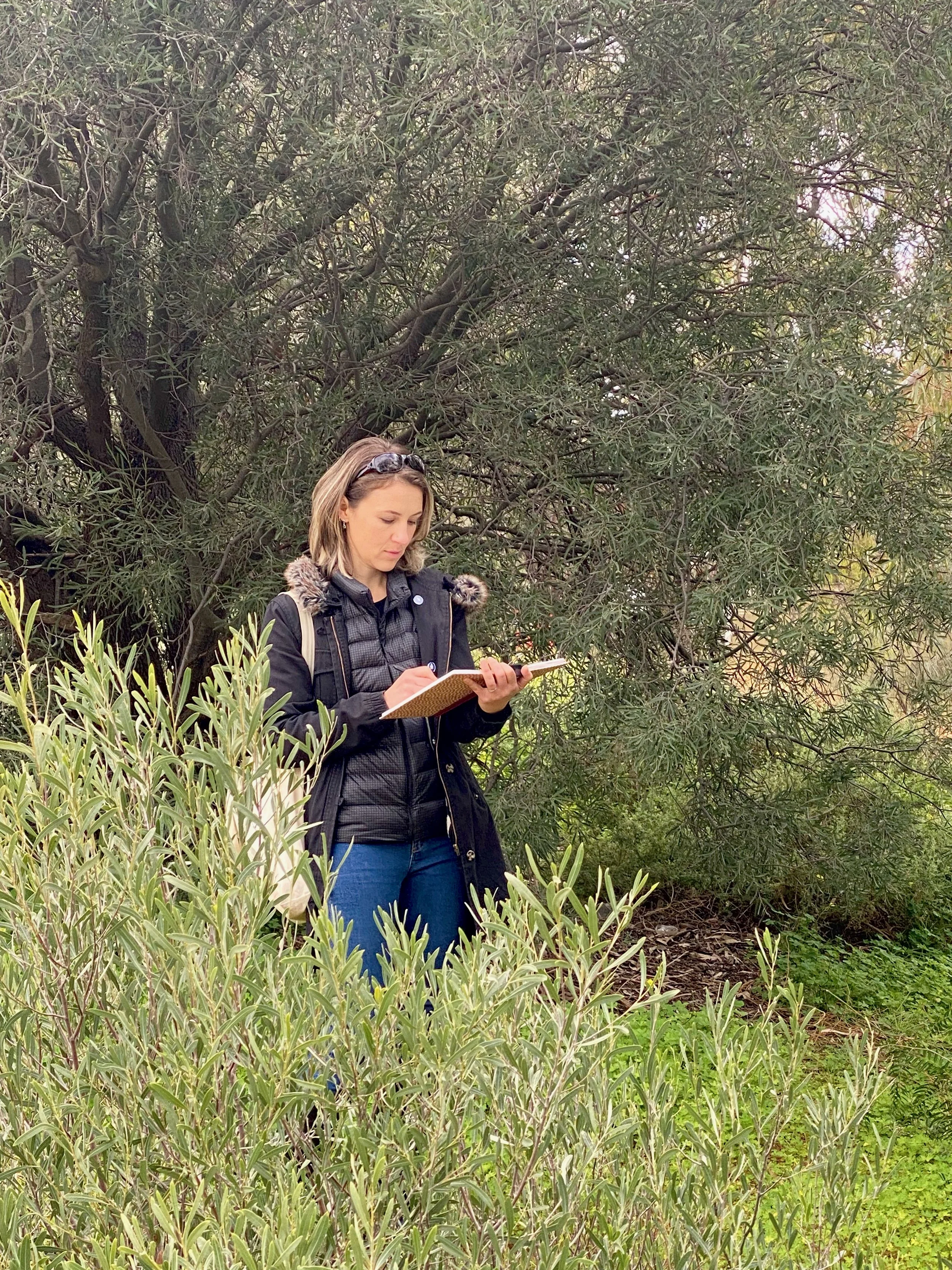 Artist working in her sketchbook outdoors