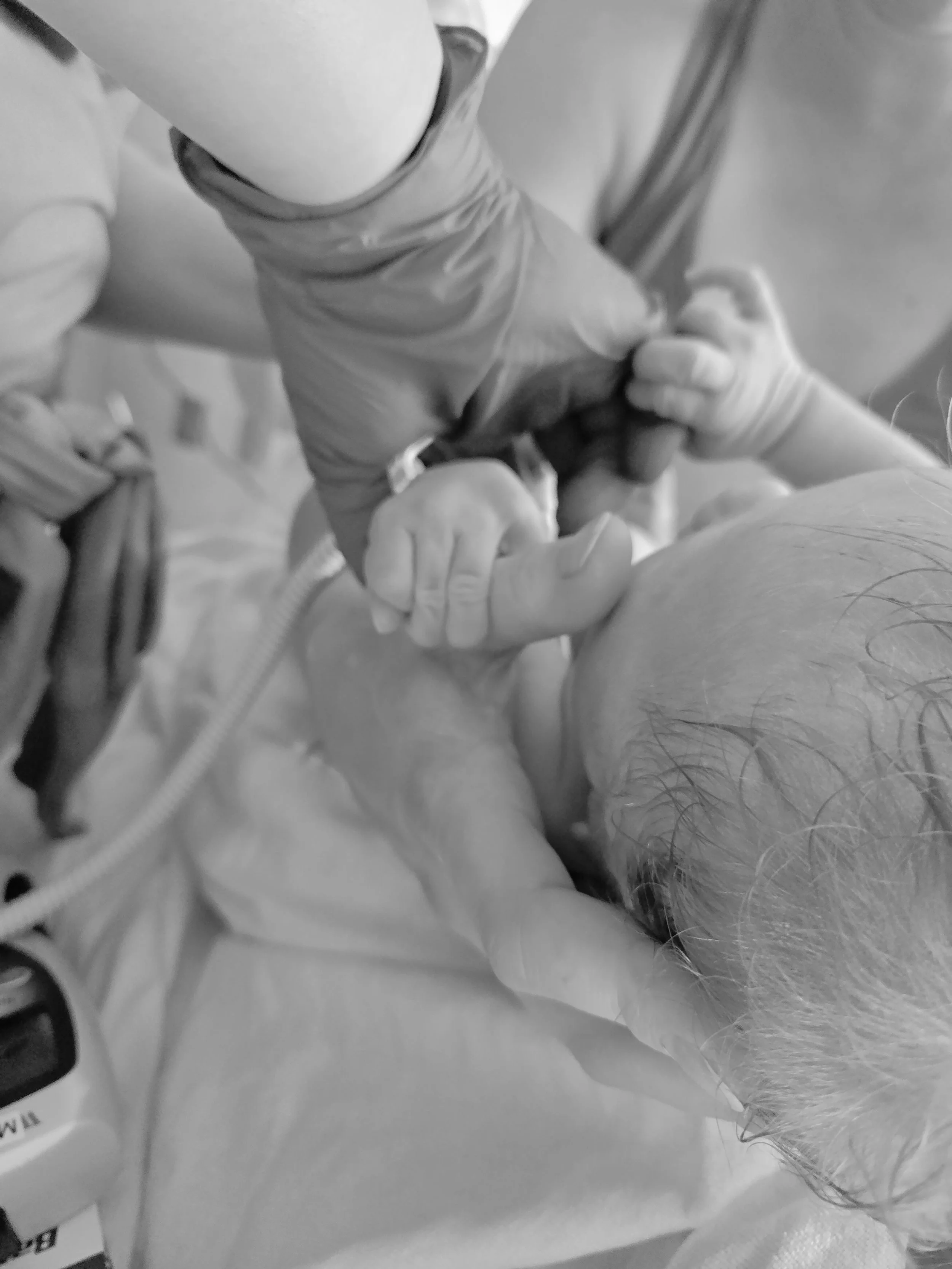 Baby Holding Nurses Hand at Hospital Birth