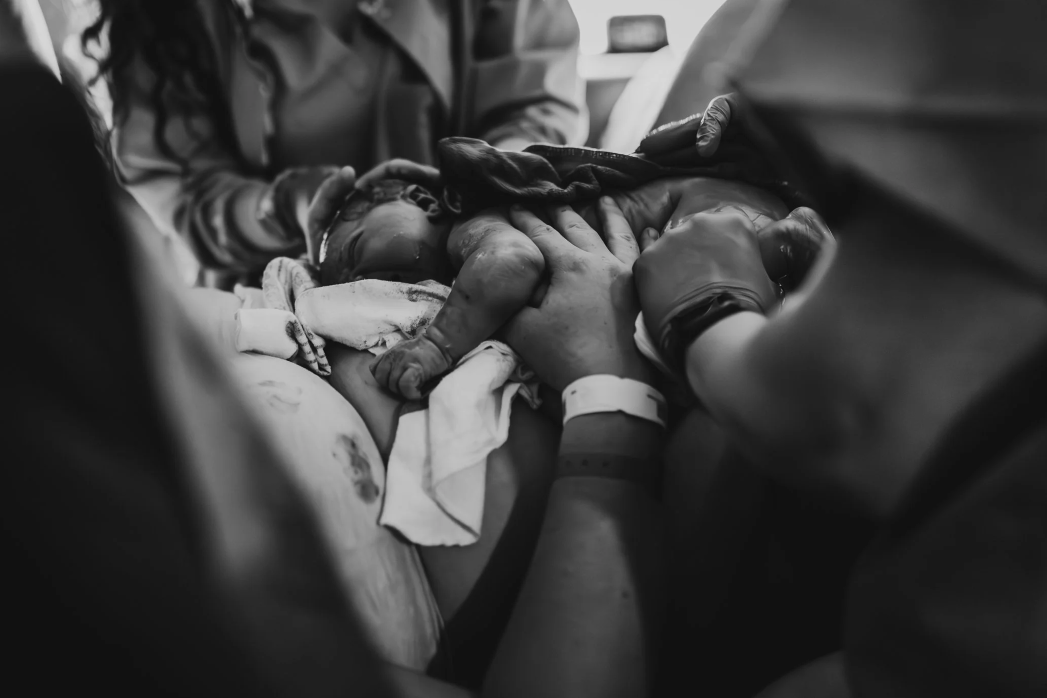 Brand new baby being placed on mom with dad and birth doula by her side in a Princeton Minnesota hospital