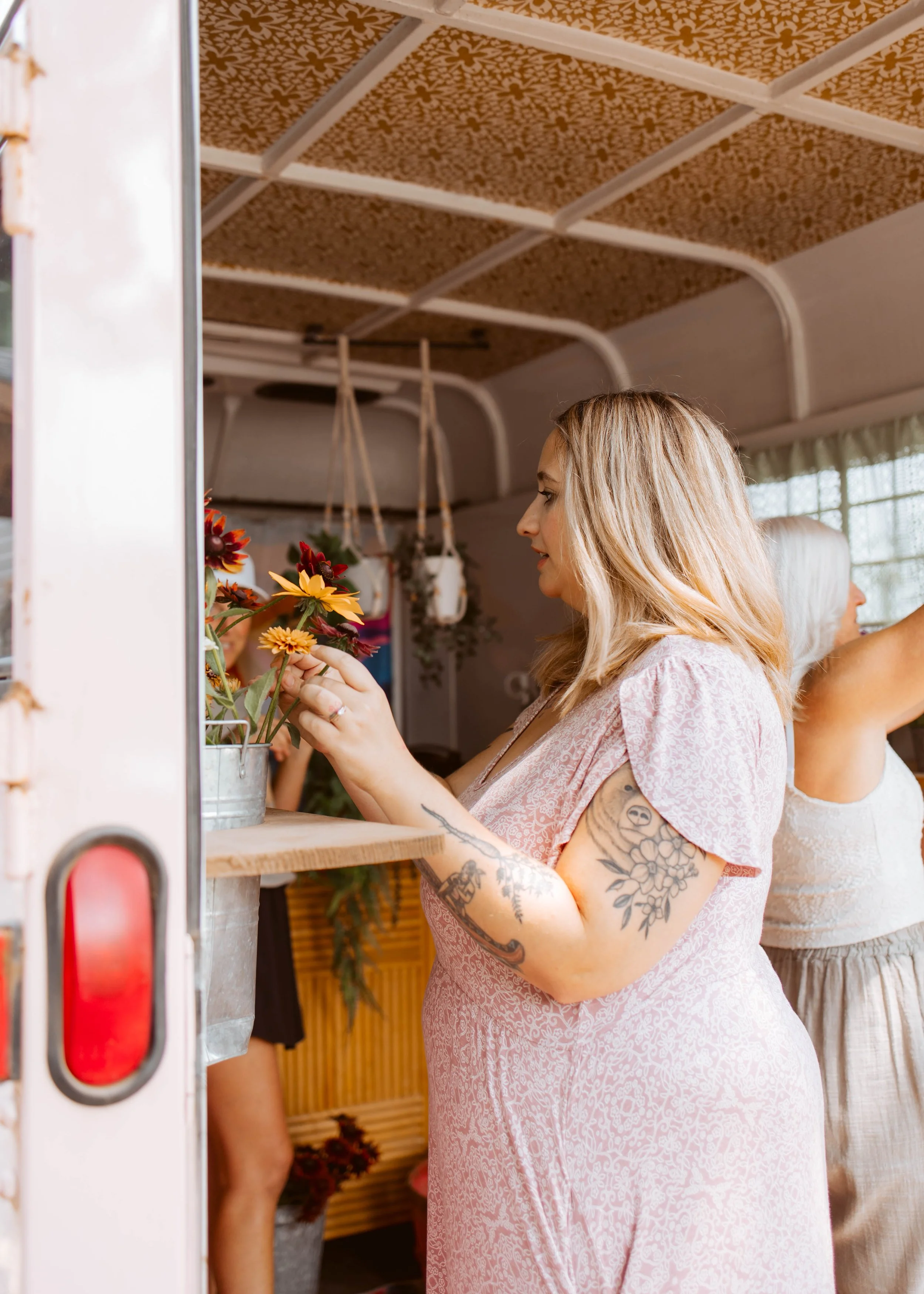 Woman In Dress Building Flower Bouquet In Trailer