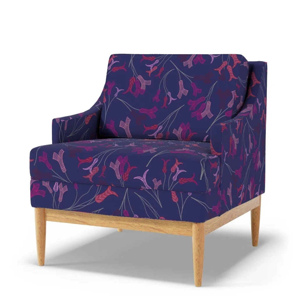 Abstract tulip stamens dance across a vibrant deep blue upholstery on a modern sofa chair
