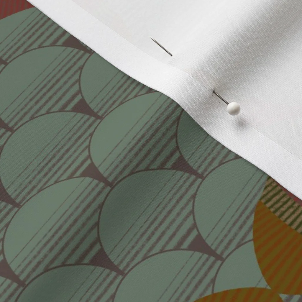 Gray green fish scale and center star design on cloth with dress-makers pin