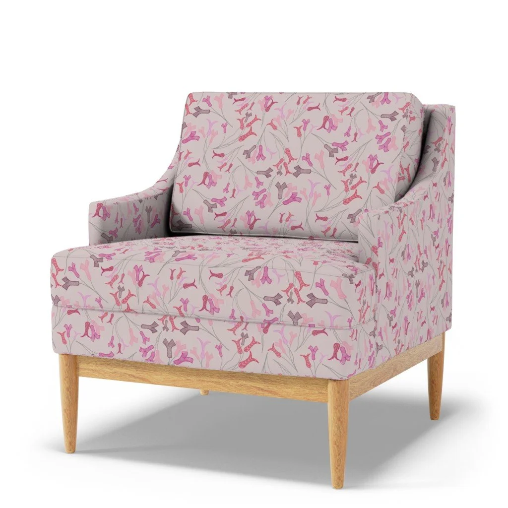 Abstract tulip stamens dance across a pale pink upholstery on a modern sofa chair