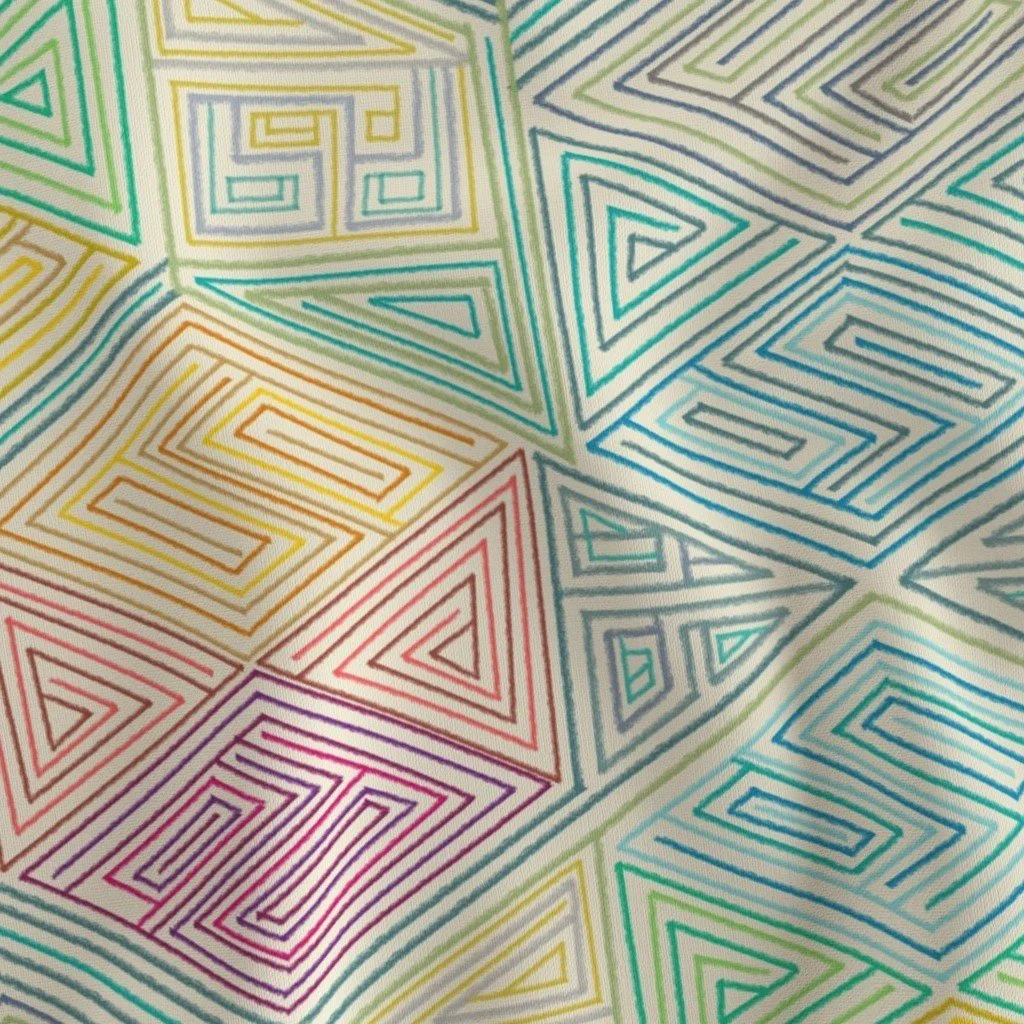Rainbow hexagon maze pattern folds across a bolt of fabri