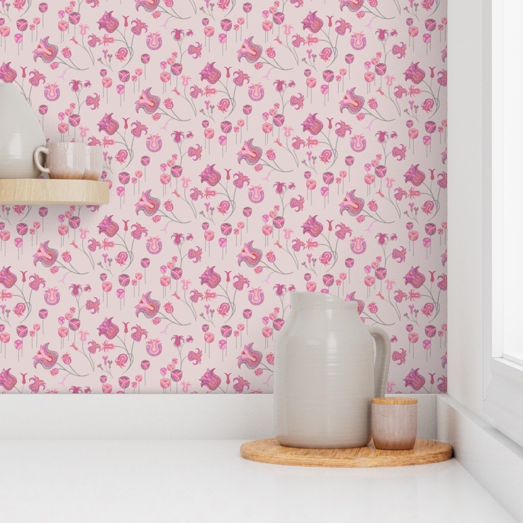 Whimsical tulips meander and sprout with detailed vibrancy against a light pink wallpaper in front of pitchers and glassware on a pristine white countertop