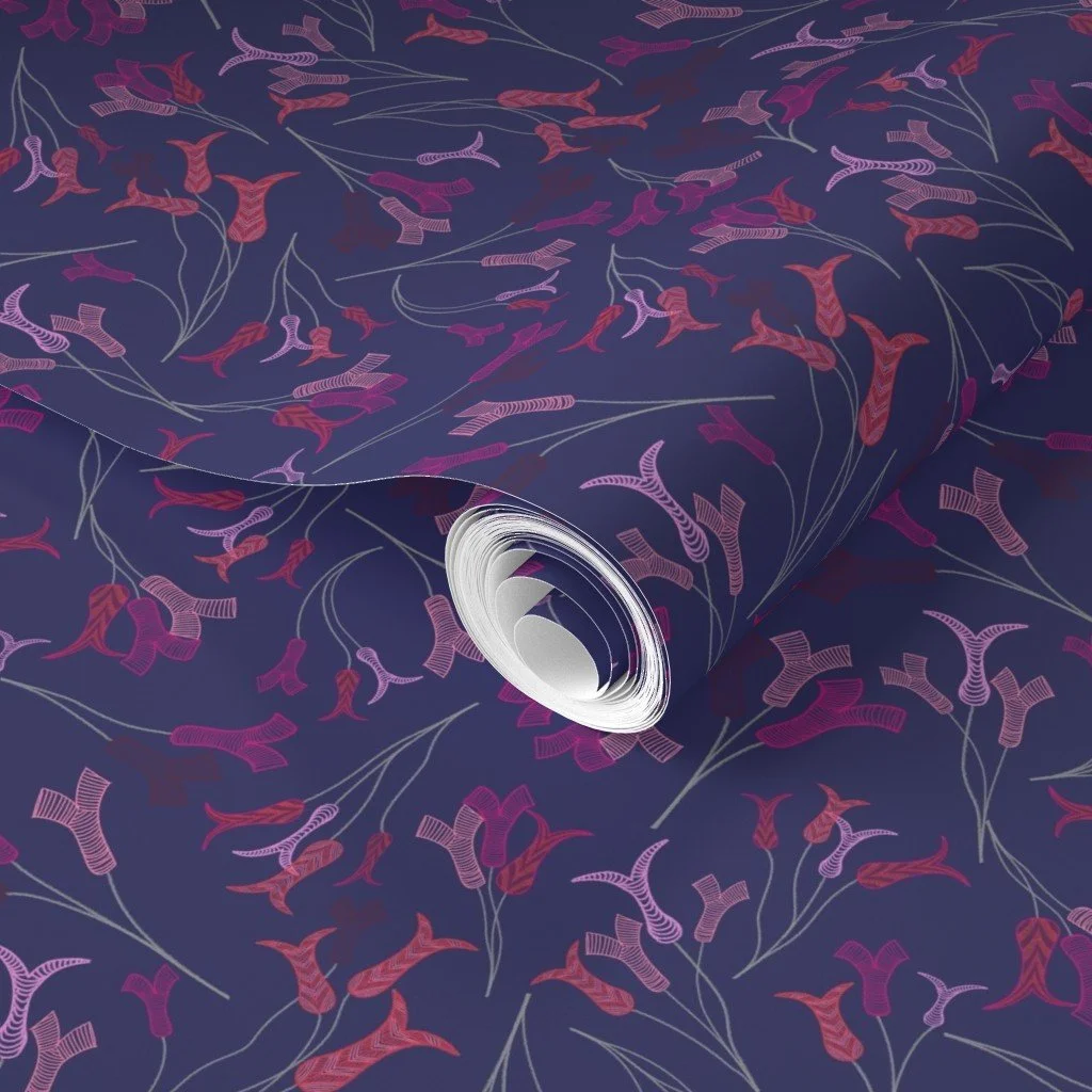 Abstract tulip stamens dance across a vibrant deep blue on a roll of wallpaper