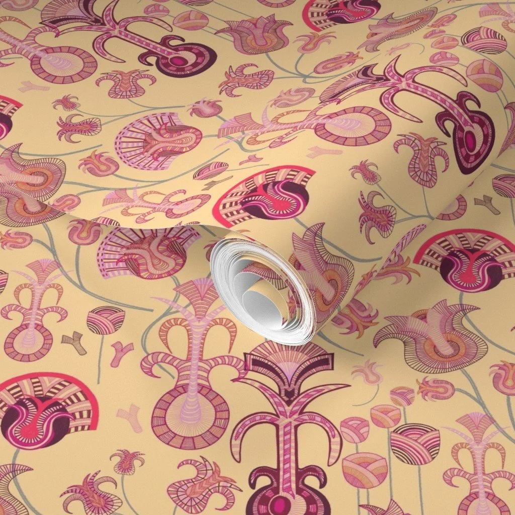 Layered tulip-like forms with intricate detail play across a warm creamy yellow roll of wallpaper