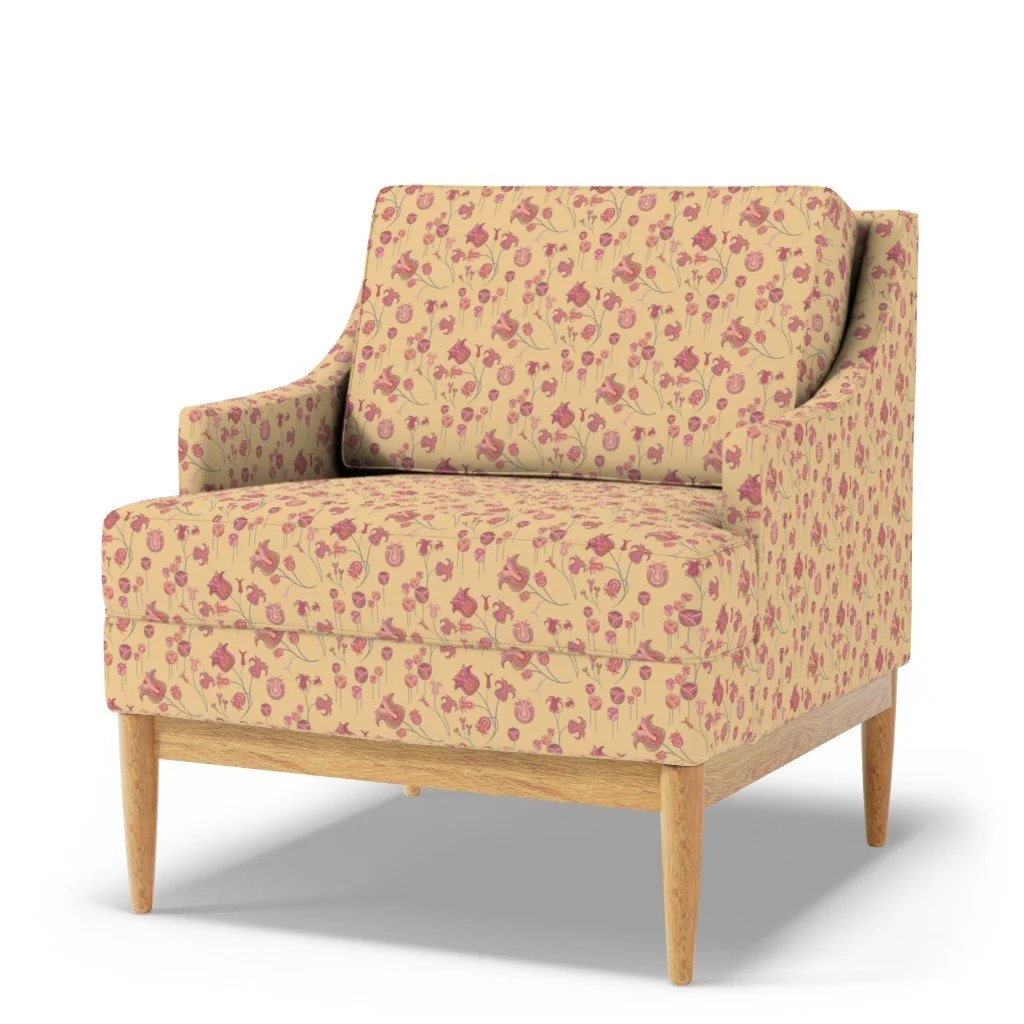 A warm yellow upholstery fabric showing whimsical tulips that meander and sprout with detailed vibrancy covers a modern sofa chair
