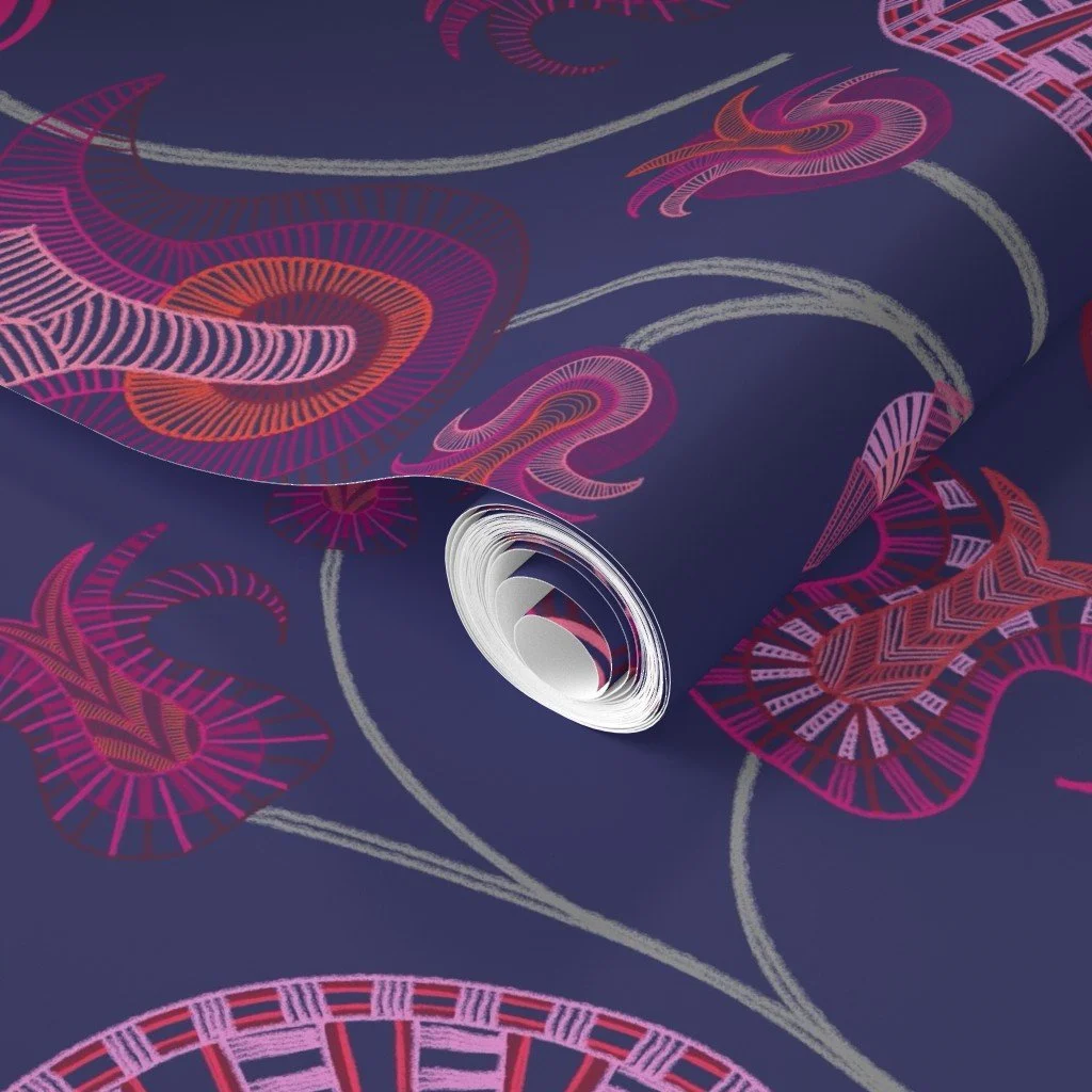 Layered tulip-like forms with intricate detail play across the vibrant blue shown on a wallpaper roll