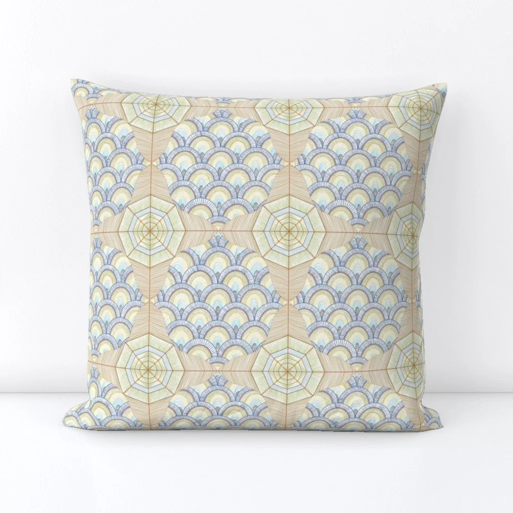 decorative fabric with compass rose and fish scale repeating motif on a throw pillow