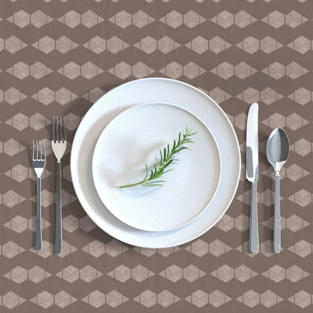 A brown and taupe hand-drawn hexagon tablecloth shown set with white plates and silverware. The pattern repeats in a small, dense scale, giving the tablecloth a subtle woven texture rather than a bold graphic.