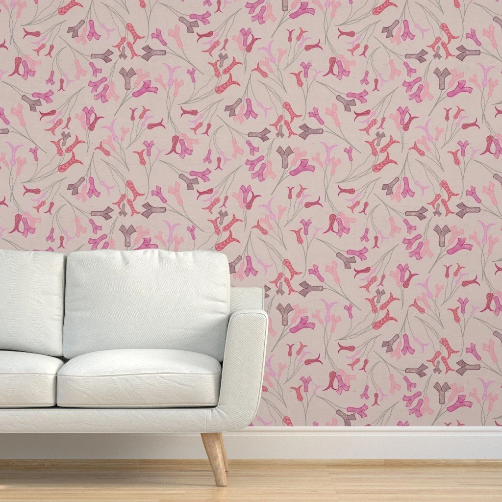 Abstract tulip stamens dance across a pale pink wall with a white contemporary sofa in front of it sitting upon a pale wood floor